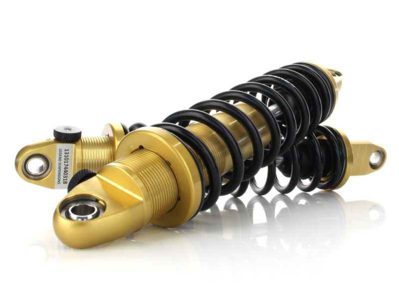 High-performance motorcycle shock absorber with gold and black details for enhanced ride quality.