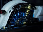 High-performance motorcycle suspension with LED lighting at Revelry Motorcycles.