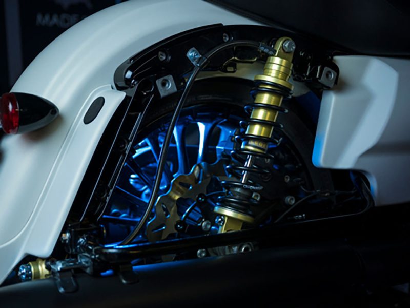 High-performance motorcycle suspension with LED lighting at Revelry Motorcycles.