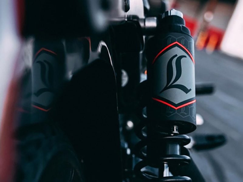 Suspension fork with Revelry Motorcycles logo, high-performance motorcycle parts.