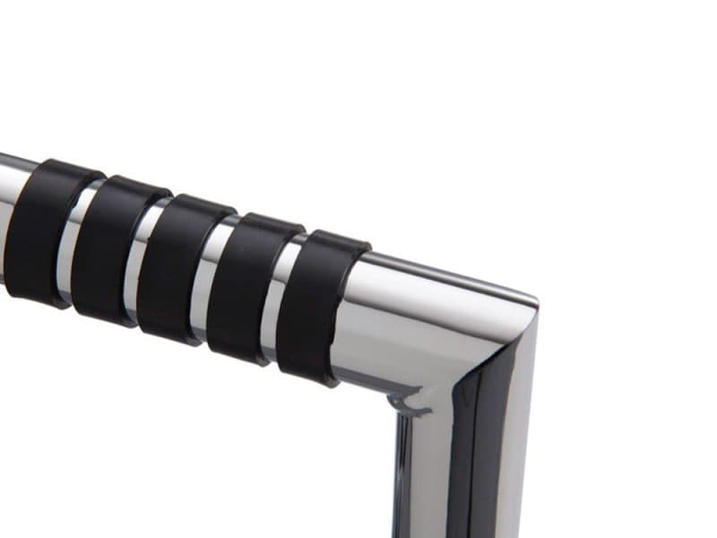 Stylish chrome motorcycle handlebar with black rubber grips for custom riding experience.