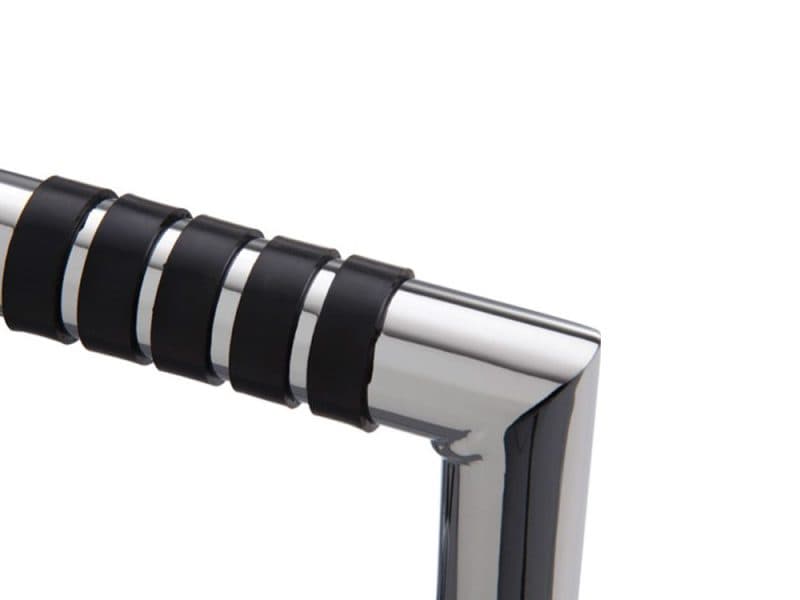 High-quality chrome motorcycle handlebar with black rubber grips for rugged riding.