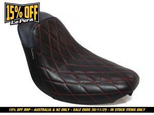 Custom motorcycle seat with black leather and red diamond stitching for Harley Davidson bikes.