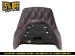 Leather motorcycle seat with diamond-stitched red accents for cafe racer style.