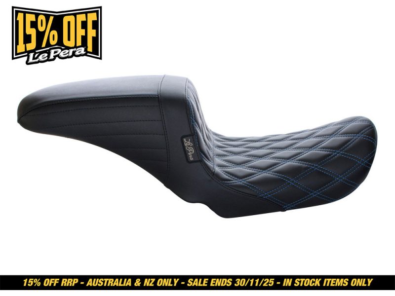 Riding motorcycle seat with quilted black leather and blue stitching for comfort and style.