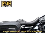 Motorcycle seat and leather saddlebag for cruiser bike, black and chrome accents.
