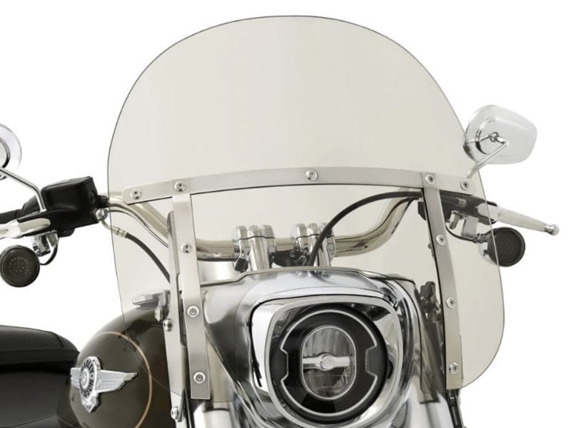 Vintage motorcycle with clear windscreen and chrome accents, perfect for cruising.