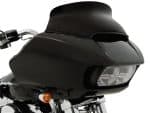 Black touring motorcycle fairing with dual headlights for Harley Davidson touring bikes, designed for improved aerodynamics and rider comfort.