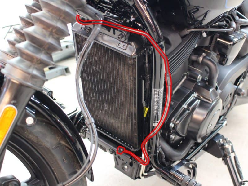 Radiator and cooling system components on Revelry Motorcycles, showcasing custom engine cooling setup.