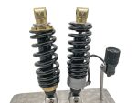 High-performance motorcycle shocks with black coil springs for Revelry Motorcycles custom builds.