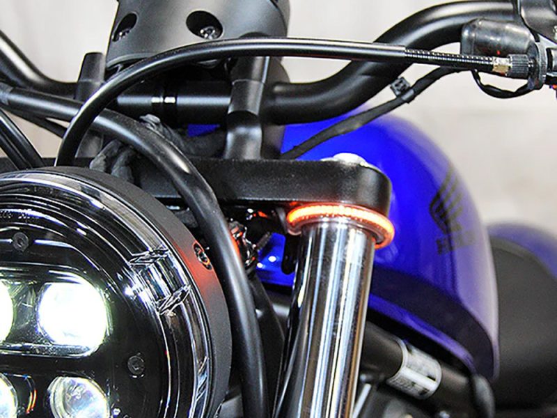 Revelry Motorcycles custom bike handlebar and headlight close-up, showcasing high-performance motorcycle parts and design.