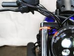 High-performance motorcycle front view with black suspension fork and LED headlight, Australian motorcycle accessories focus.