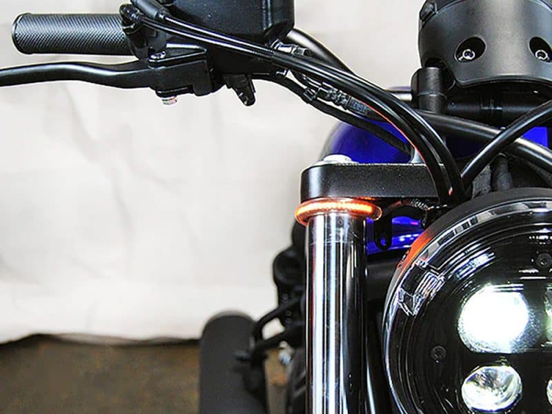 High-performance motorcycle front view with black suspension fork and LED headlight, Australian motorcycle accessories focus.