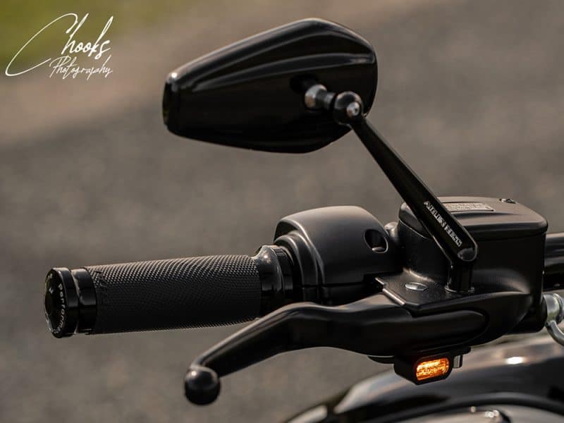 High-quality motorcycle handlebar with mirror and grip, perfect for Revelry Motorcycles.