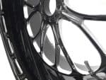 High-performance motorcycle wheel with sleek black and chrome finish for Harley Davidson bikes.