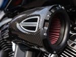Carbon fibre motorcycle performance air intake with "Performance Machine" branding, high-performance motorcycle accessory.