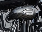Carbon fibre motorcycle air filter housing with "Performance Machine" branding.