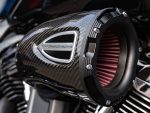 High-performance motorcycle air filter with carbon fibre casing and red air intake, ideal for enhancing bike power and efficiency.