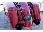 Red motorcycle trunk with dual exhaust pipes and "Bagger Nation" badge.