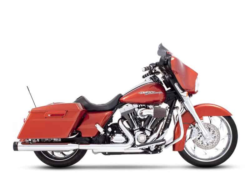Harley Davidson touring motorcycle with orange paint, luggage compartments, chrome accents.