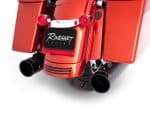 Vivid red motorcycle exhaust pipes with "Revelry Motorcycles" branding, showcasing custom racing exhausts.