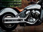 Sleek Indian Scout Motorcycle with chrome exhaust pipes and leather seat.