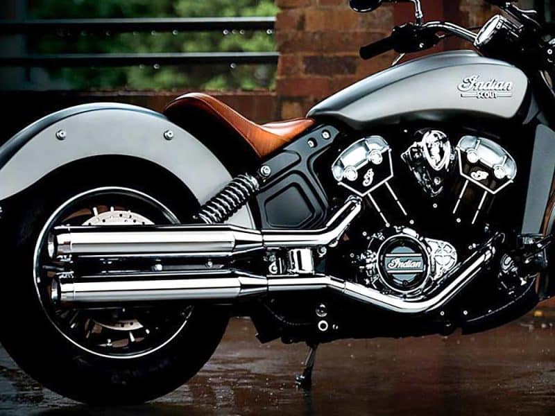 Sleek Indian Scout Motorcycle with chrome exhaust pipes and leather seat.