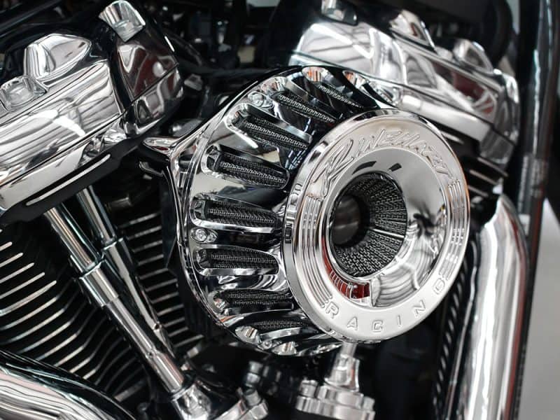 Shiny chrome motorcycle engine close-up, high-performance Harley-Davidson custom parts.
