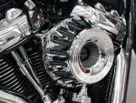 Shiny chrome motorcycle engine with "Vance & Hines" branding, highlighting high-performance parts for bikes.