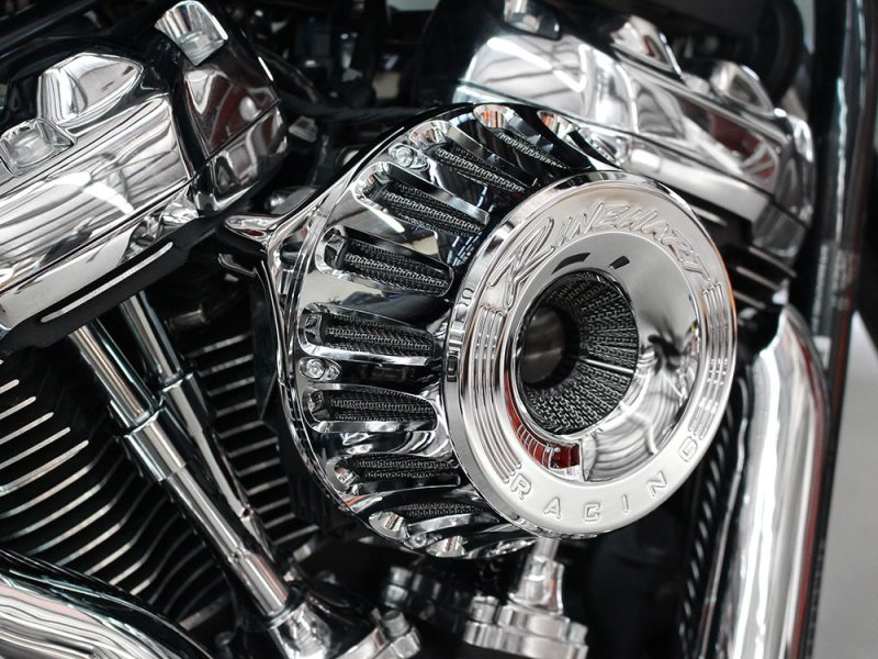 Shiny chrome motorcycle engine with "Vance & Hines" branding, highlighting high-performance parts for bikes.