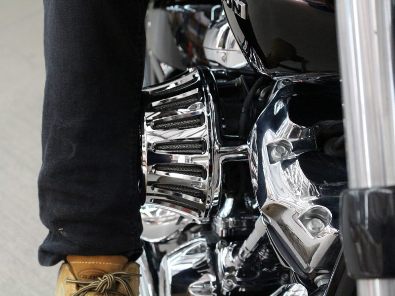 Vibrant chrome motorcycle engine with black accents, showcasing Revelry Motorcycles' custom design and craftsmanship.