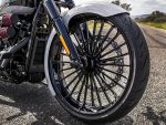 Aerodynamic motorcycle front wheel with custom black alloy rim and disc brake, ideal for Harley Davidson touring bikes.