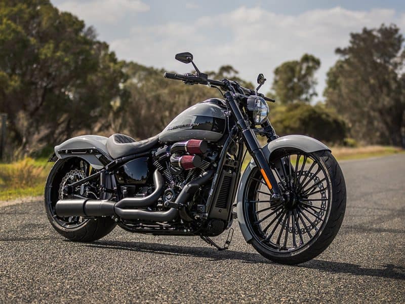 Vivid black and grey custom motorcycle with modern design on open road.