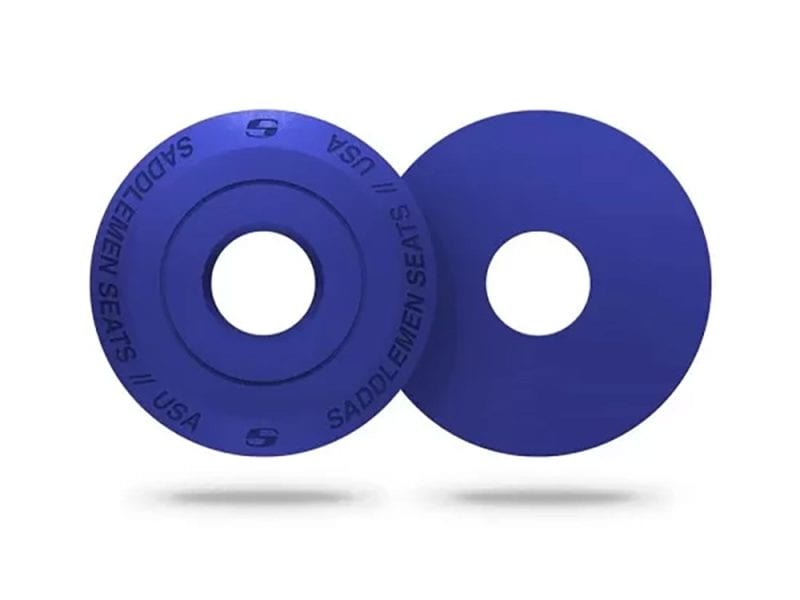Blue motorcycle seat spacer discs for Revelry Motorcycles, focus on custom motorcycle parts.