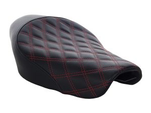 Vespa motorcycle seat with black leather and red quilted stitching for comfort and style.