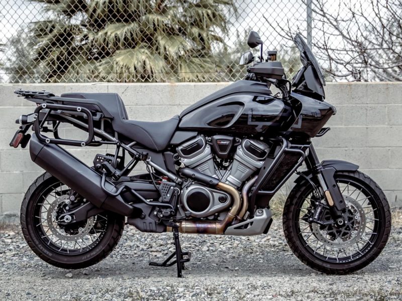 Sleek black adventure motorcycle with rugged tires and storage options, ideal for long-distance touring and off-road adventures.
