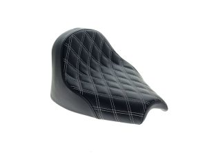 Luxurious black quilted motorcycle seat for revelry and comfort.