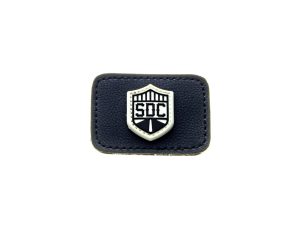 Leather motorcycle badge with shield logo and "SOC" text, perfect for motorcycle gear or apparel.