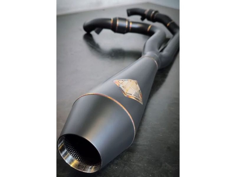 2-into-1 4.5in. Big Bore Exhaust With ProFlo Headers - Black Onyx. Fits Touring 2017up High-performance motorcycle exhaust pipe painted black with gold accents for Revelry Motorcycles in Australia.