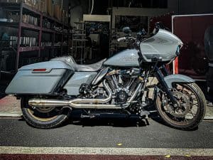 Harley Davidson motorcycle with custom grey paint and touring accessories.