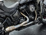 Sleek black motorcycle with custom exhaust and intricate branding details, perfect for motorcycle enthusiasts.