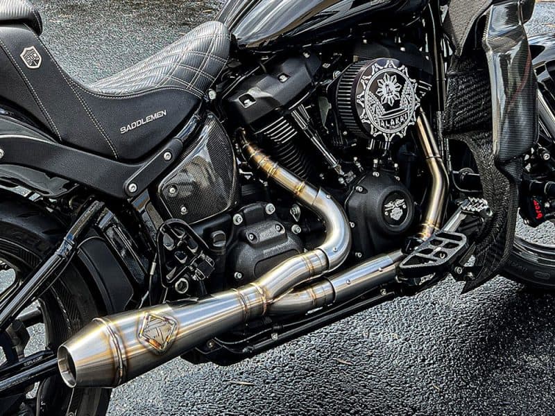Sleek black motorcycle with custom exhaust and intricate branding details, perfect for motorcycle enthusiasts.