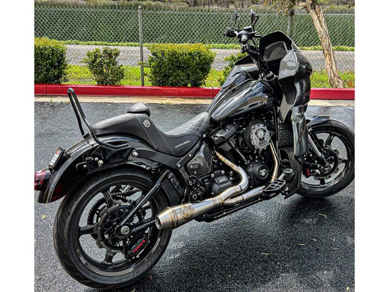 Black Harley-Davidson cruiser motorcycle with custom exhaust and touring fairing for sale at Revelry Motorcycles in Australia.