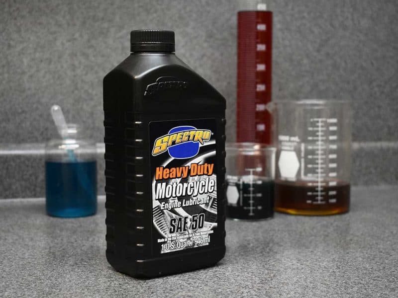 High-quality motorcycle engine lubricant in a black bottle with Revelry Motorcycles branding.