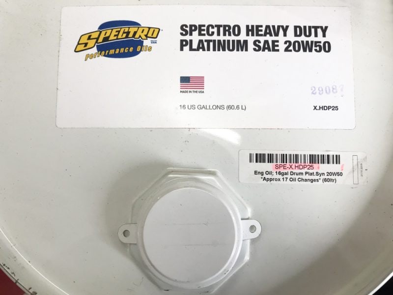 Spectro Heavy Duty Platinum SAE 20W50 motor oil container, 16 US gallons, made in USA, for motorcycle engine maintenance.