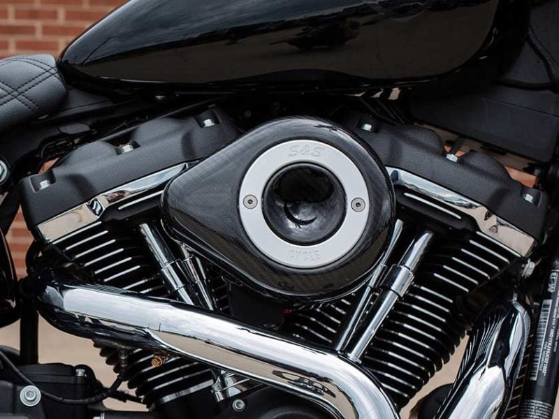 V-twin motorcycle engine with chrome parts and black details, showcasing high-performance bike specifications.