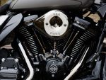 Shiny chrome Harley-Davidson motorcycle engine with black cooling fins, showcasing premium craftsmanship.