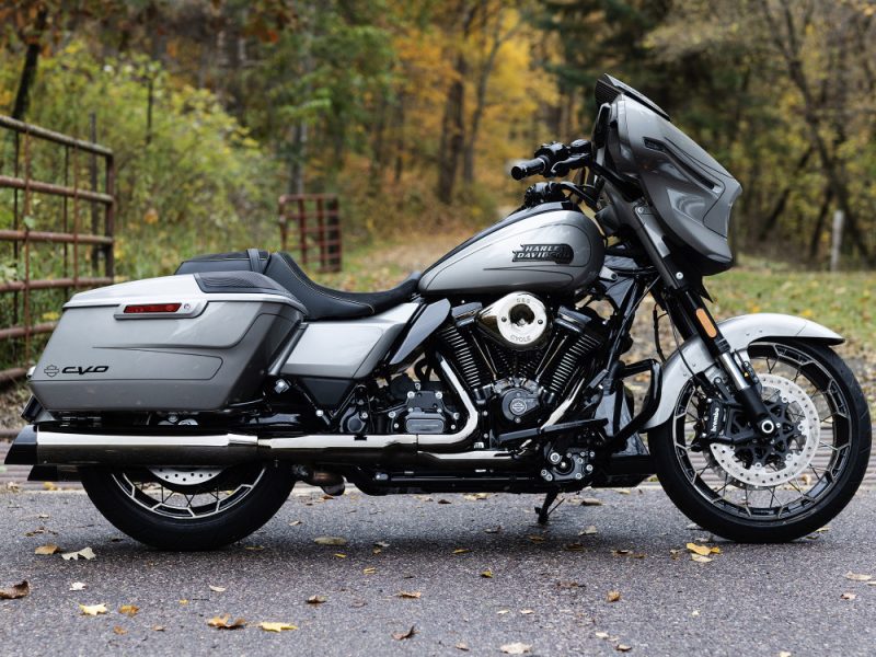 Harley Davidson touring motorcycle on an autumn scenic road.