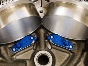 High-performance motorcycle engine components with precise blue anodised parts.