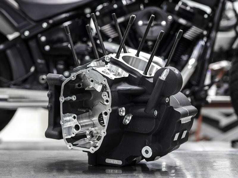 Crankcase Assembly - Black. Fits Softail 2018up High-performance motorcycle engine combat parts in a workshop setting.